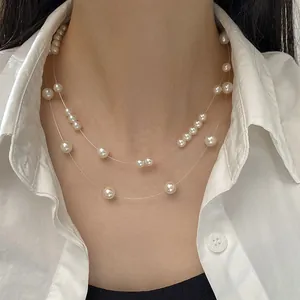 Close-up of double-layer starry pearl necklace on transparent fish-line worn by model