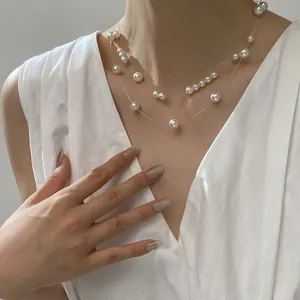 Close-up detail of a double-layered faux pearl necklace with invisible fishing line