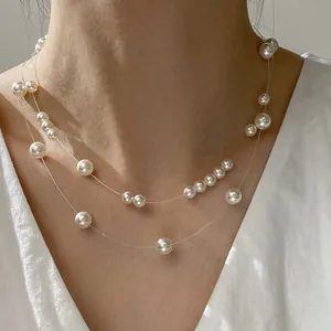 Close-up of elegant double-layered necklace with floating pearls on invisible line.