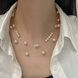 Detail view of double-layer starry pearl necklace with transparent fishing line choker