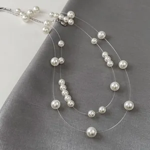 Detailed macro view of elegant double-layered pearl necklace with transparent fishline.