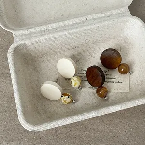 Detailed view of minimalist retro wood stud earrings with natural stone beads.