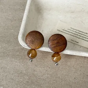 Vintage wood and natural stone stud earrings with a rustic design and warm tones.