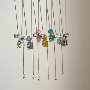 Close-up of Dalmatian stone and natural bead long necklaces with adjustable chains