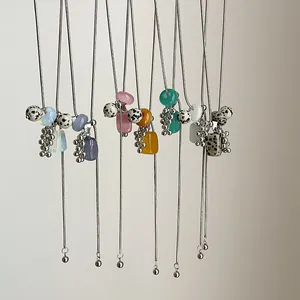Detailed view of adjustable Dalmatian stone grape cluster necklaces in various colors