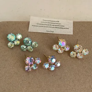 Close-up detail of rainbow crystal flower stud earrings in three elegant colors