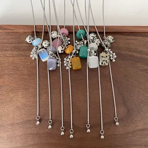 Close-up of adjustable long necklaces with dalmatian stones and colorful beads
