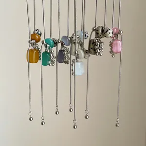 Selection of adjustable Dalmatian stone necklaces with colorful cat's eye stone pendants