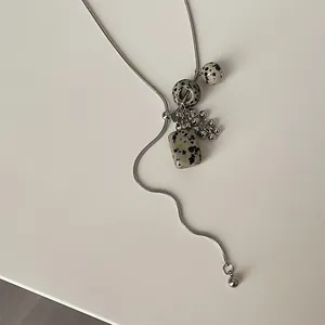 Long silver necklace featuring natural Dalmatian stone pendants and grape cluster beads.