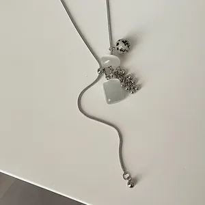 Detailed view of silver serpentine lariat necklace with dalmatian stone and bead cluster