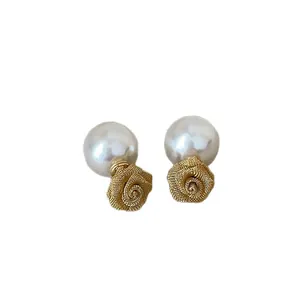 Elegante oorknopjes met mesh roos en imitatieparel in gouden afwerking.