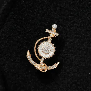 Detailed macro shot of an exquisite gold-toned crystal rhinestone anchor brooch for men