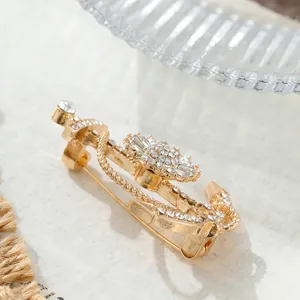 Detailed view of luxury golden anchor brooch with sparkling rhinestones for men's suit
