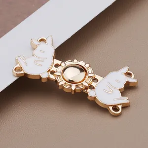 Close-up of vintage gold metal bunny buckle with white enamel for traditional Hanfu