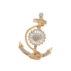 Close-up of golden anchor brooch with sparkling crystal rhinestones for men's suit