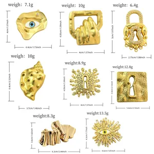 Detailed dimensions and weights for various gold-toned abstract and evil eye brooches.