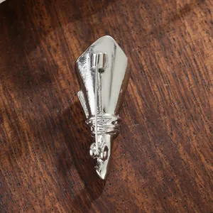 Detailed back view of a creative silver DIY flower-inserting brooch on wood