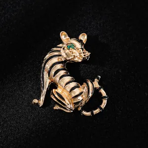 Elegant detail of a vintage gold tiger brooch with black stripes and green emerald eyes