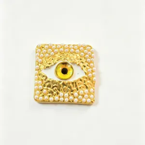 Gold evil eye brooch with white pearls and irregular hammered texture detail view