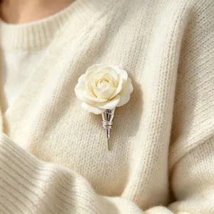 Elegant white rose brooch with silver metal stem holder detail on knit sweater