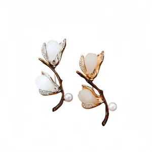 Elegant magnolia flower brooches with pearls and rhinestones in gold and silver tones