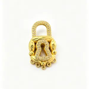 Detailed view of a gold-plated padlock brooch with crystal pavé and hammered texture