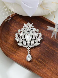 Exquisite detail view of a vintage silver crystal brooch featuring a teardrop pendant.