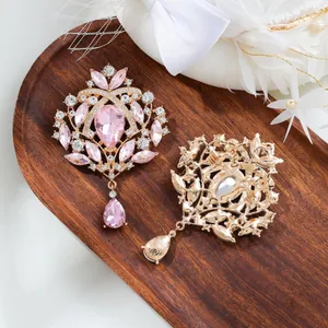 Vintage pink crystal brooch with teardrop pendant in elegant gold alloy setting, front and back.