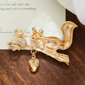 Detailed view showing the back pin mechanism of the cute squirrel and acorn brooch.
