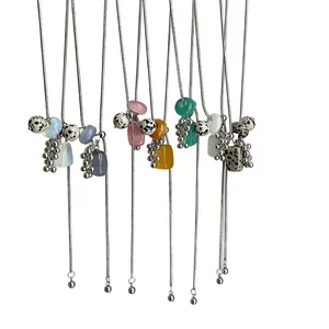 Elegant long adjustable necklace featuring natural dalmatian stones and grape clusters
