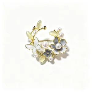 Detail van vintage bloemenkrans broche met elegante parels en mooie kattenoogstenen
