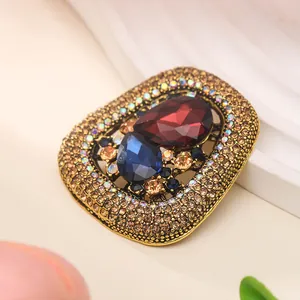 Close-up of vintage luxury crystal brooch with red and blue teardrop rhinestones