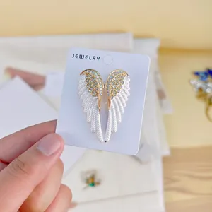 Eleganter Engelsflügel-Brosche mit weißer Emaille und funkelnden Strasssteinen