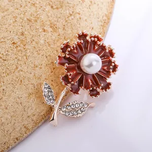Elegant red carnation flower brooch pin with central pearl and rhinestone leaves detail.