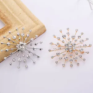Detailed view of gold and silver snowflake brooches with sparkling crystal rhinestones