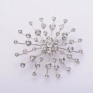 Detailed macro view of a sparkling snowflake brooch featuring clear crystal rhinestones
