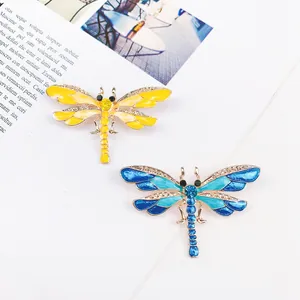 Vintage dragonfly brooches in yellow and blue colors with sparkling crystals