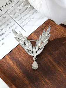 Elegant silver angel wing brooch detail featuring sparkling marquise cut clear crystals