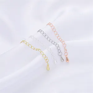 Detail of four metallic jewelry extension chains with teardrop charms for DIY work