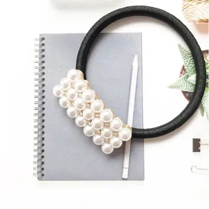 Elegant black elastic hair tie decorated with white pearls and sparkling rhinestones