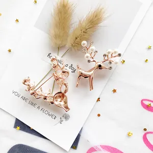 Elegant Christmas pearl reindeer brooch pins with rhinestones in a rose gold finish