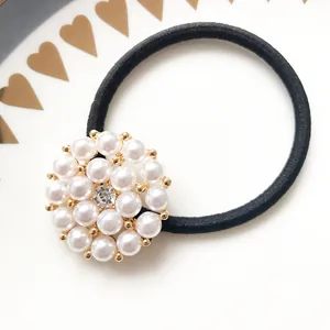Elegant black elastic hair tie with circular pearl and rhinestone floral ornament