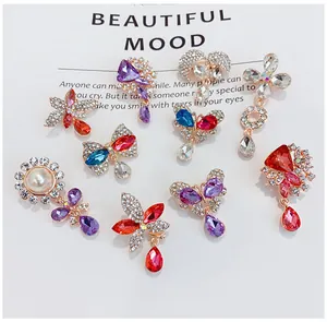 Detailed view of various colorful crystal butterfly and floral brooches with rhinestones