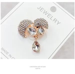 Close-up of elegant rhinestone bow brooch with teardrop crystal pendants