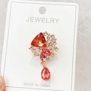 Elegant orange gemstone brooch pin with crystal rhinestones on jewelry card