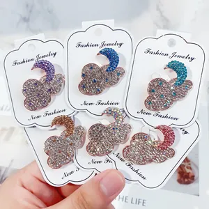 Collection of colorful rhinestone cloud and moon brooches on fashion jewelry display cards