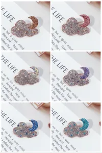 Collection of six colorful rhinestone cloud and moon brooches in various vibrant shades