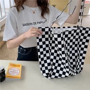 Detailed view of large black and white checkerboard canvas tote bag for daily use