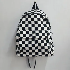Classic black and white checkered canvas backpack with a detailed front zip pocket