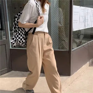Lifestyle view of a large black and white checkerboard canvas backpack for women students